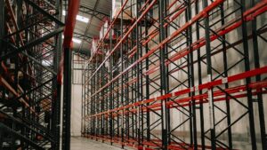 Real warehouse aisle with pallet racks and concrete floor